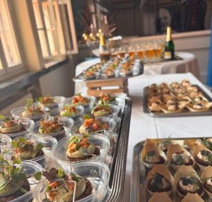 Table with various appetizers and drinks in a casual setting